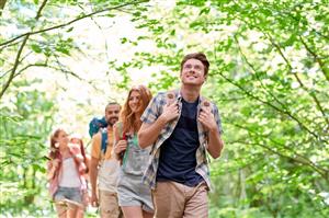 group of adults hiking in woods